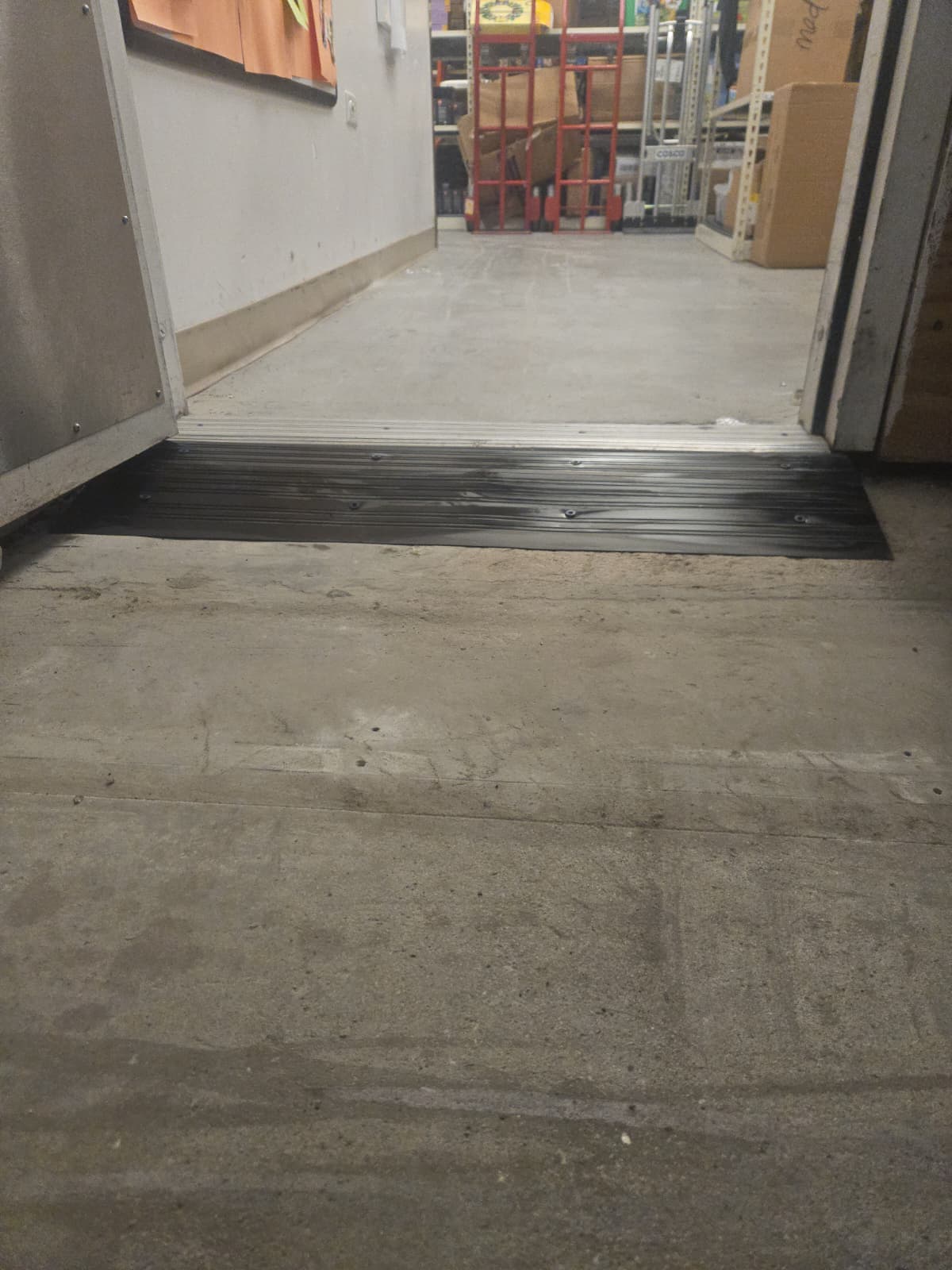 A Step at a Sunrise Stockroom Door Was Blocking Dollies and Carts photo 2